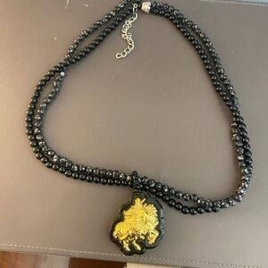 Black beaded costume jewelry necklace gold tone pendant horse/ knight (?) EUC